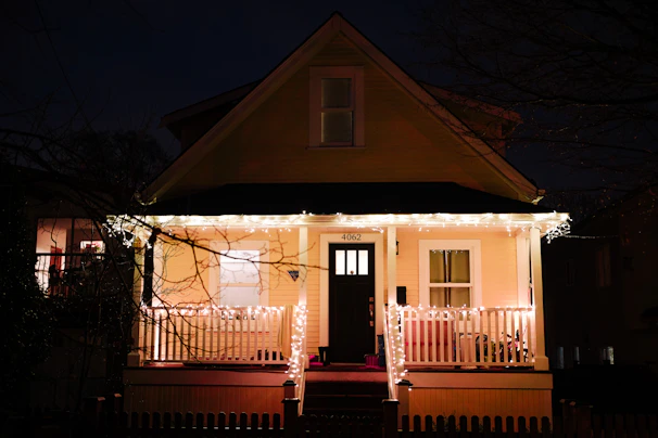 Cozy guest house exterior with welcoming lights at dusk in Srirangam.