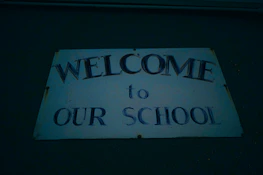 The principal warmly greeting students on the school campus.