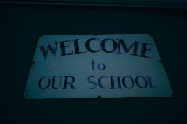 A welcoming school entrance with bright blue and white banners, showcasing the school's name.
