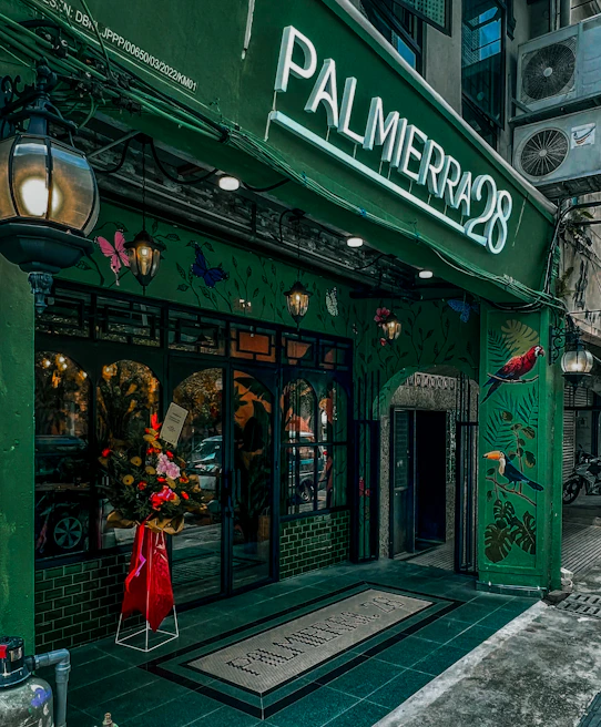 Exterior view of a bustling airesucursal storefront with customers entering