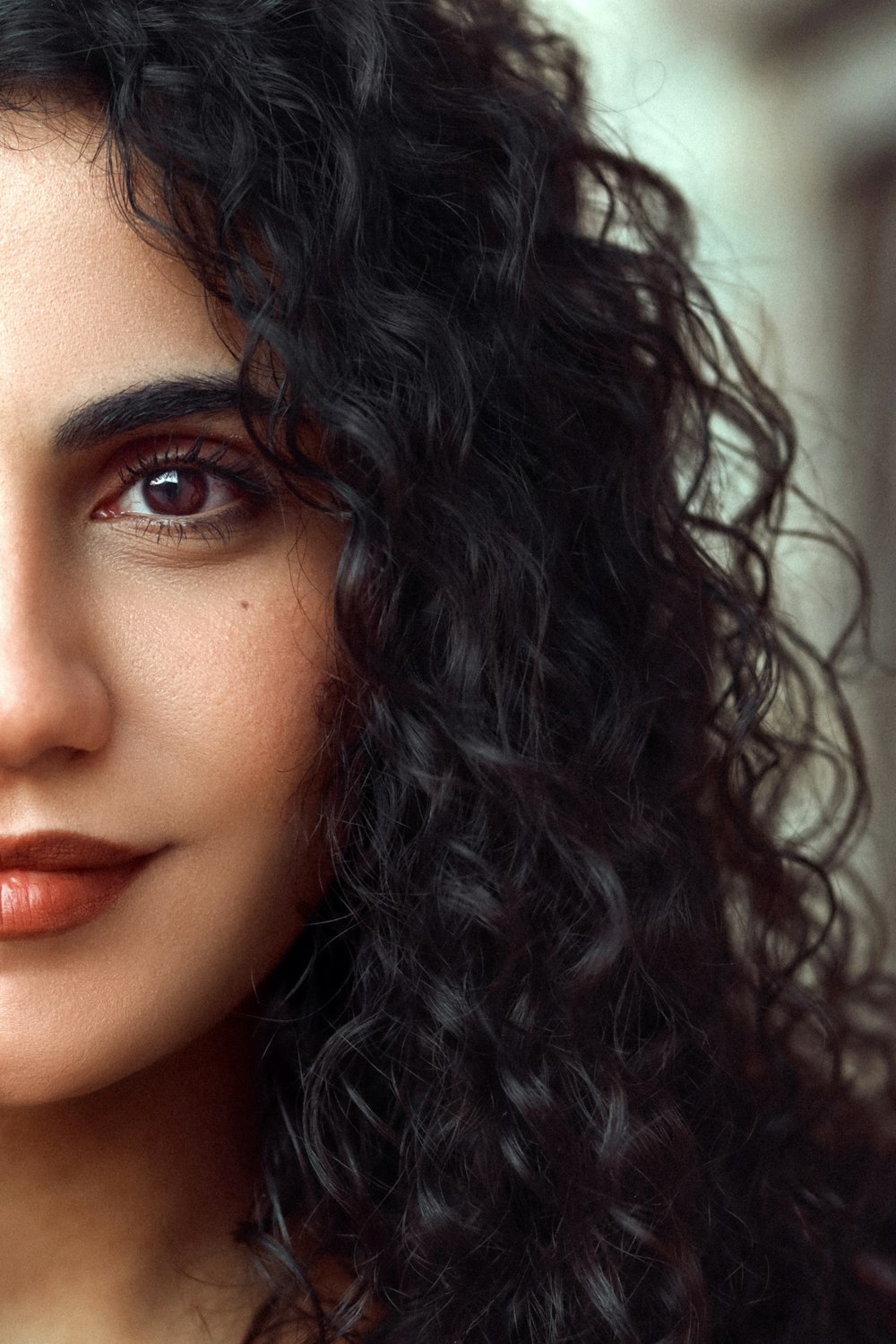 a close up of a woman with curly hair