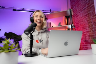 a woman sitting in front of a laptop computer