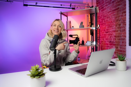 a woman sitting in front of a laptop computer