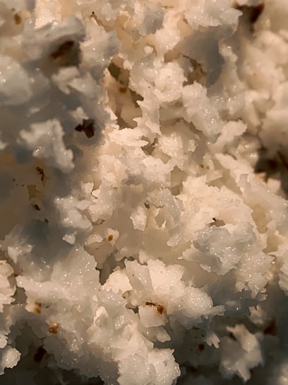 A close-up of tartar crystals on a wooden surface.