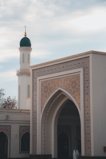 a large white building with a green dome