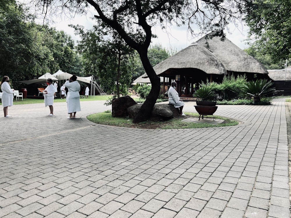 a group of people standing around a tree