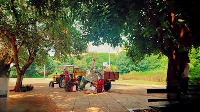 A group of enthusiastic youths gathered around a tractor, learning modern farming techniques.