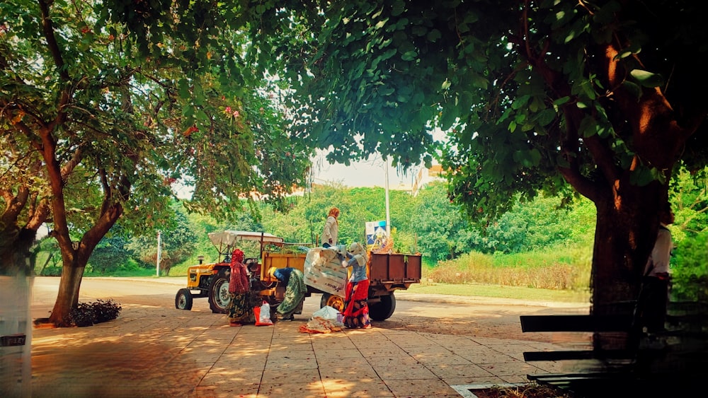 a man standing next to a truck under a tree