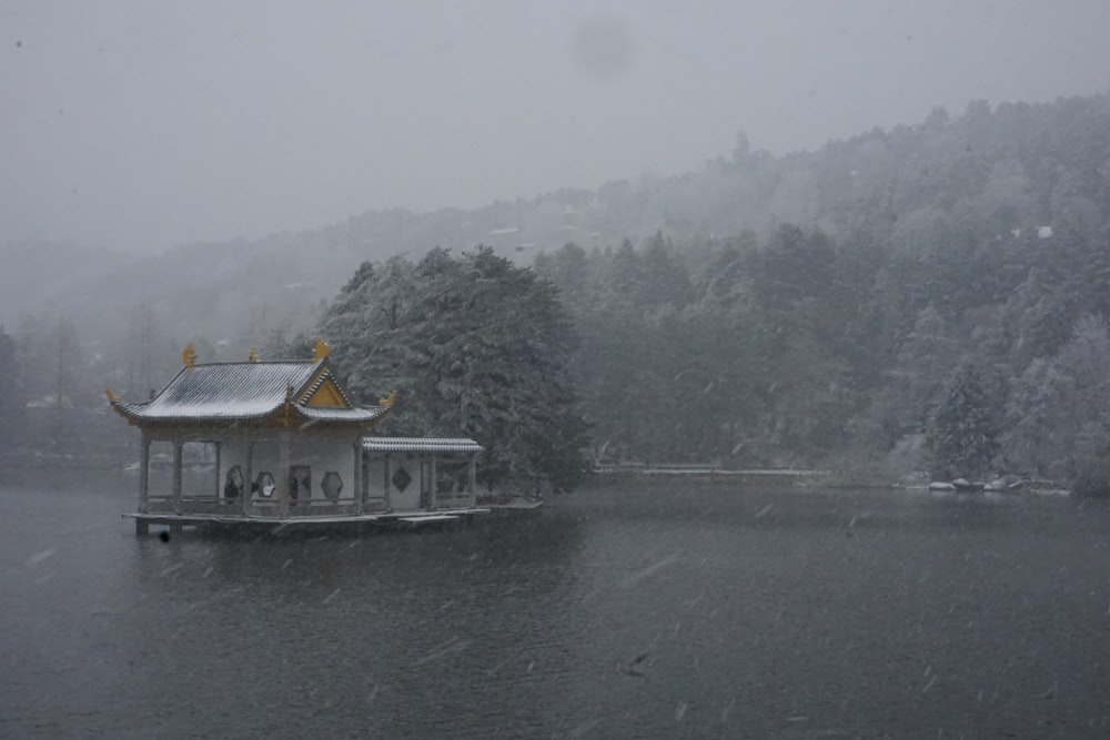 a boat floating on top of a lake covered in snow