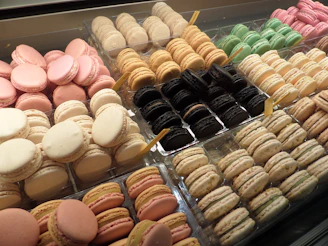An assortment of colorful macarons arranged neatly on a pastel tray.