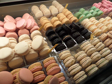 An assortment of colorful macarons arranged neatly on a pastel tray.