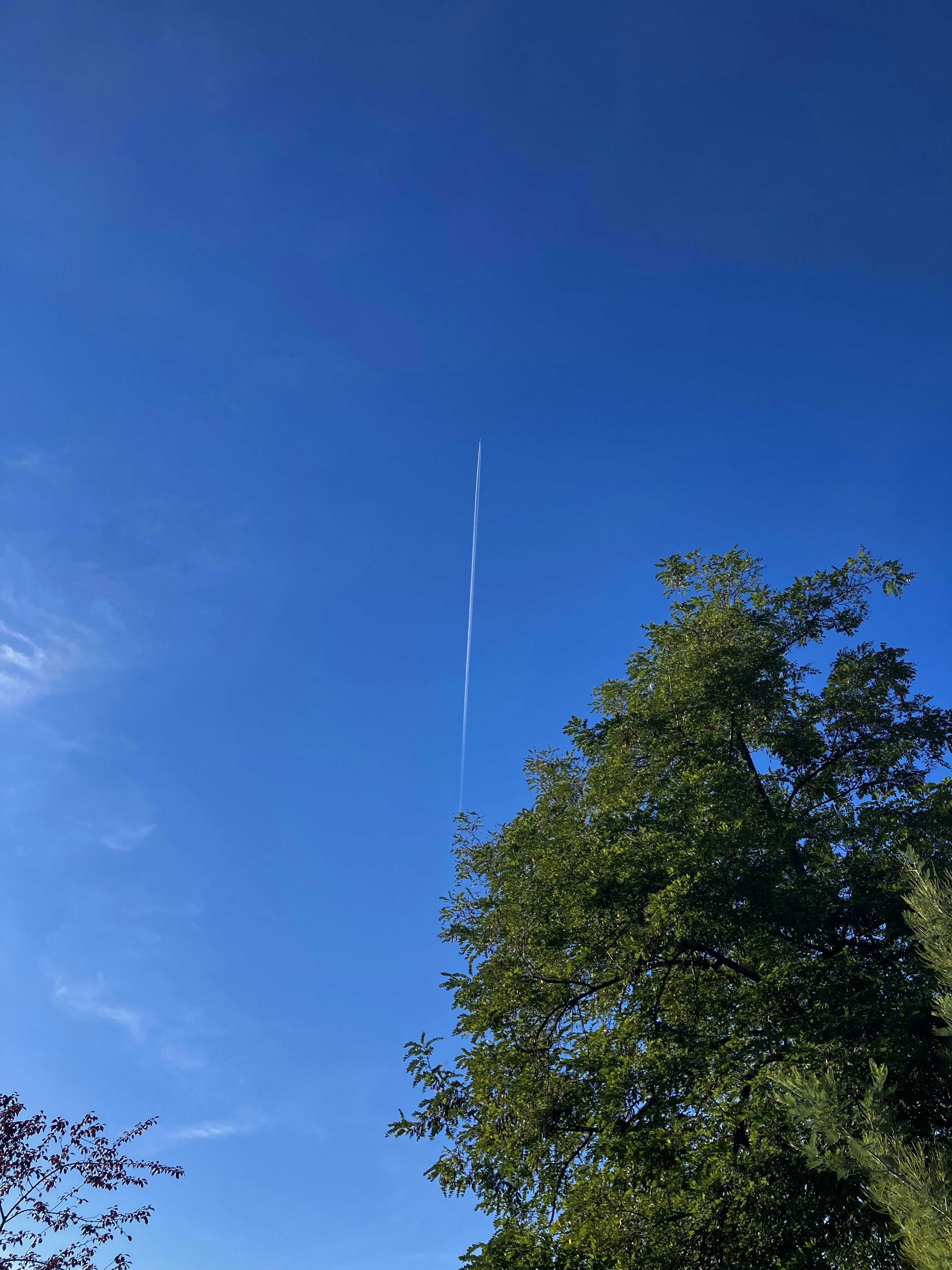 an airplane is flying high in the sky