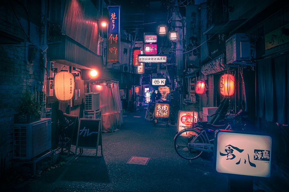 a dark alley with a bicycle parked in the middle of it