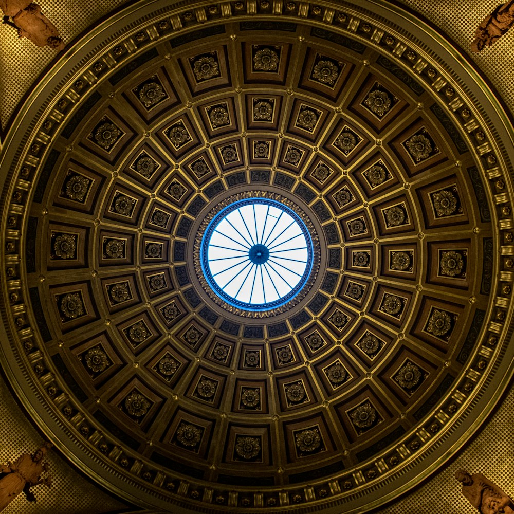 a circular ceiling with a blue skylight in the center