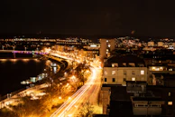 Nighttime cityscape of Vijayawada with illuminated bridges and bustling streets.