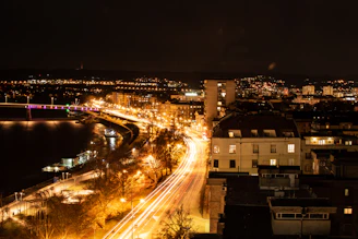 Nighttime cityscape of Vijayawada with illuminated bridges and bustling streets.