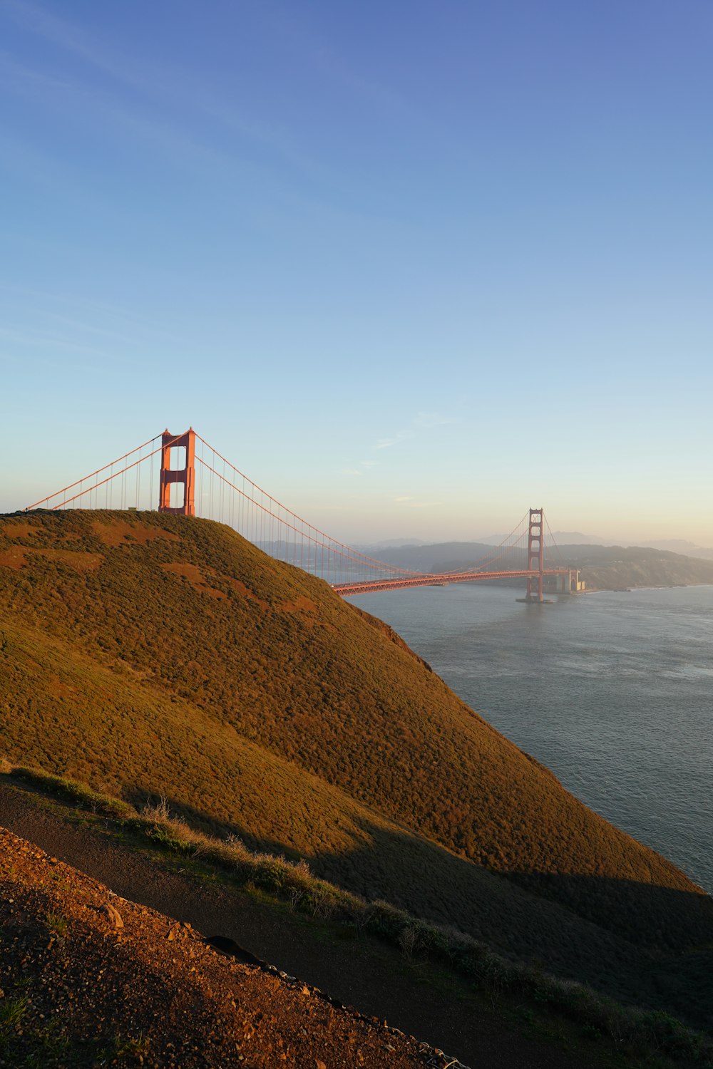 a view of the golden gate bridge from the top of a hill