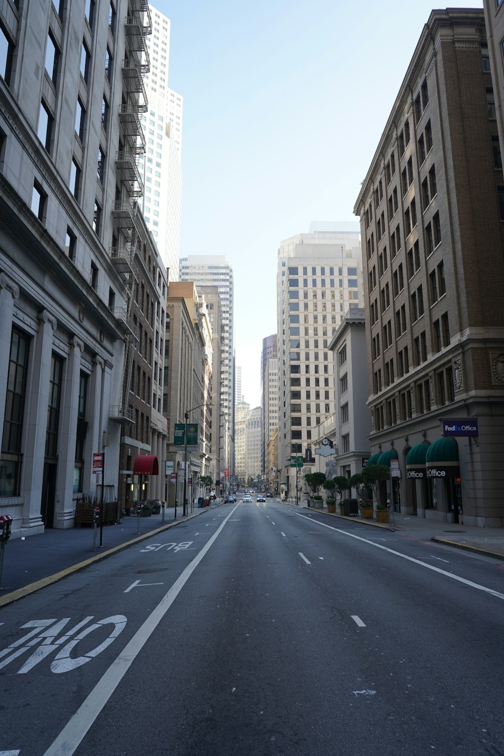 an empty street in a city with tall buildings