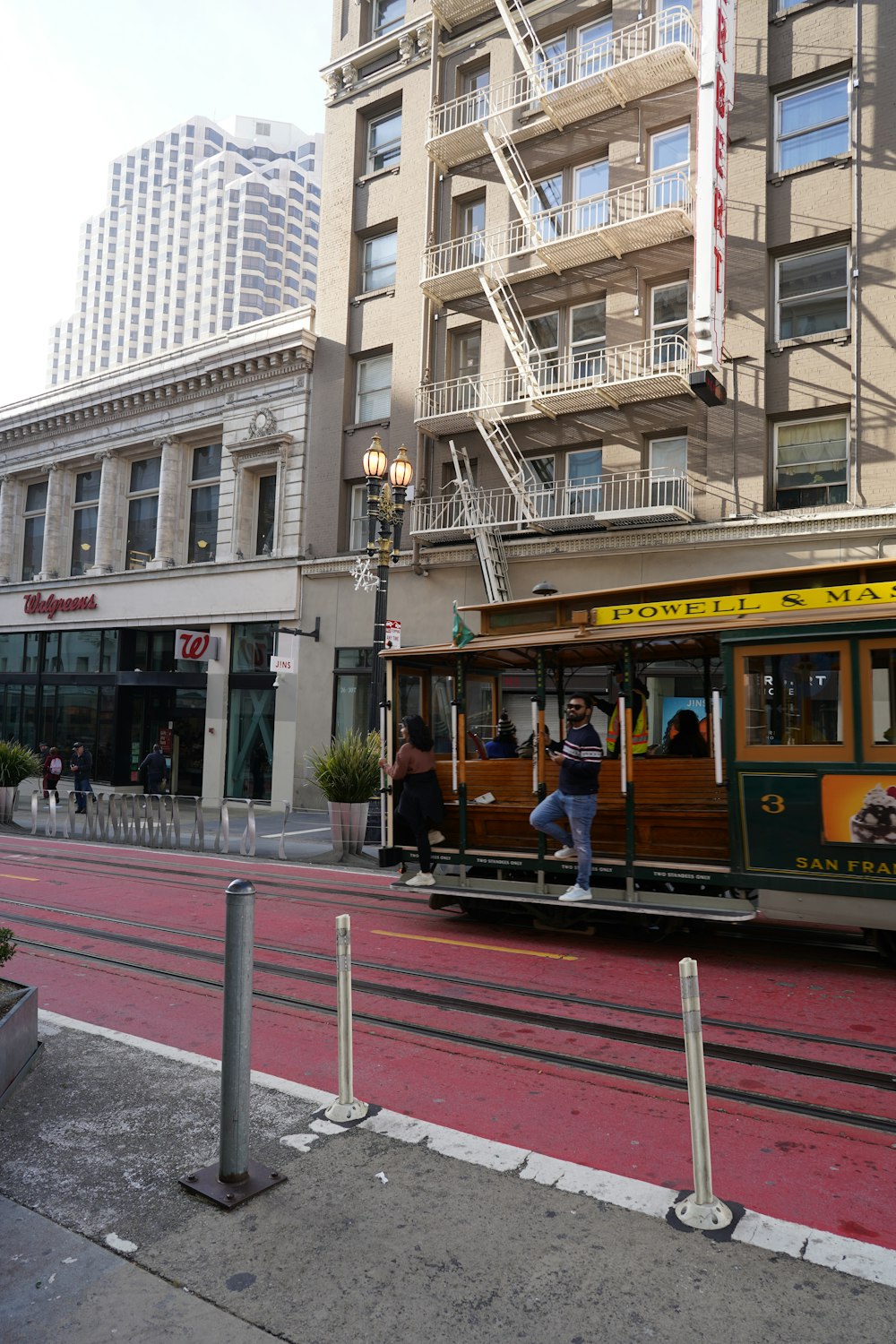 a trolley car on a city street with a building in the background