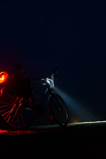 Bright front and rear lights mounted on an electric bike, illuminating a nighttime street.