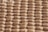 A close-up view of a honeycomb structure made from cardboard, featuring a repeating geometric pattern. The cells are hexagonal and crafted from a light brown paper material, giving a textured appearance with shadows that enhance the depth and structure.