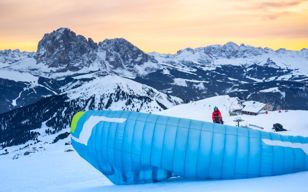 a large inflatable object sitting on top of a snow covered slope