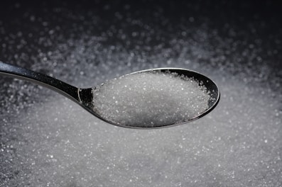 Crystalline white cane sugar reflecting light softly.