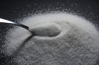 a spoon full of sugar on top of a table