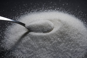 a spoon full of sugar on top of a table