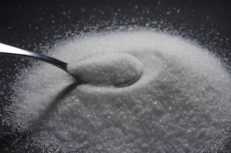 a spoon full of sugar on top of a table