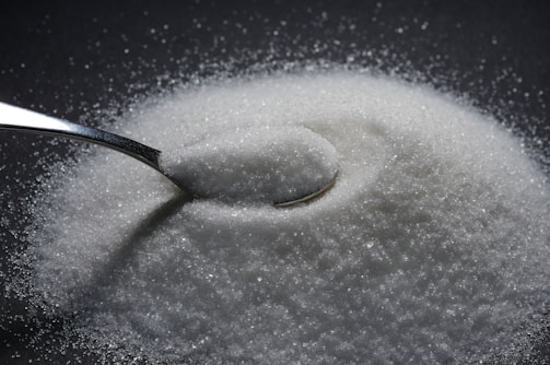 a spoon full of sugar on top of a table