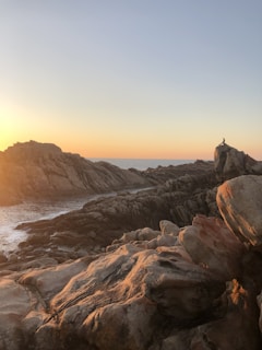Sunrise casting golden light over the rocky coastline of Acadia National Park.