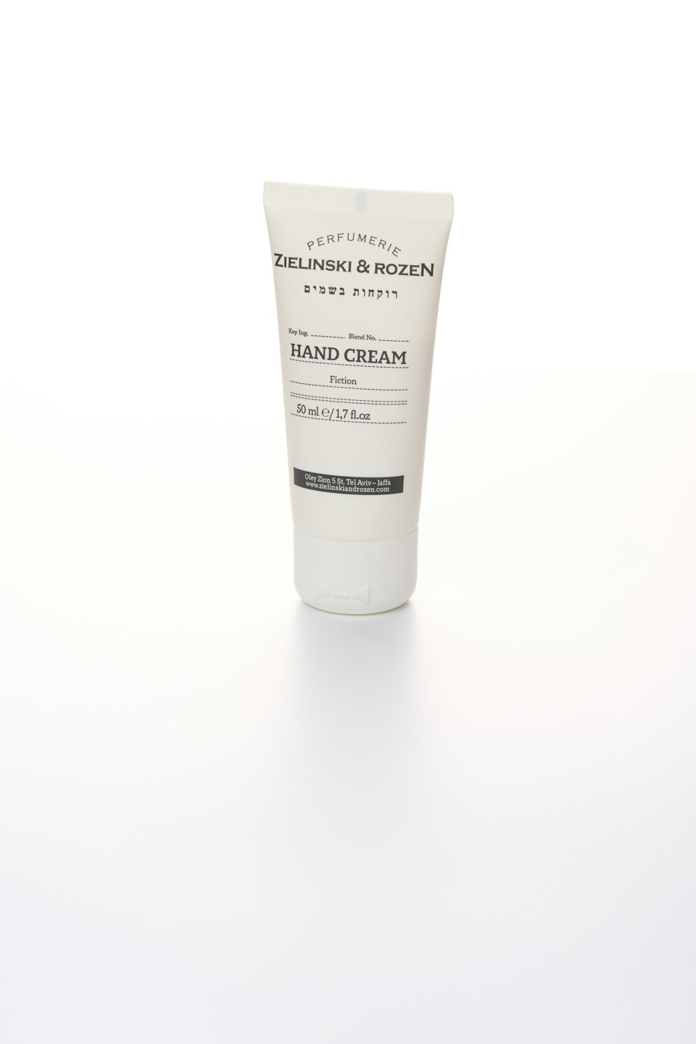 a tube of hand cream on a white surface