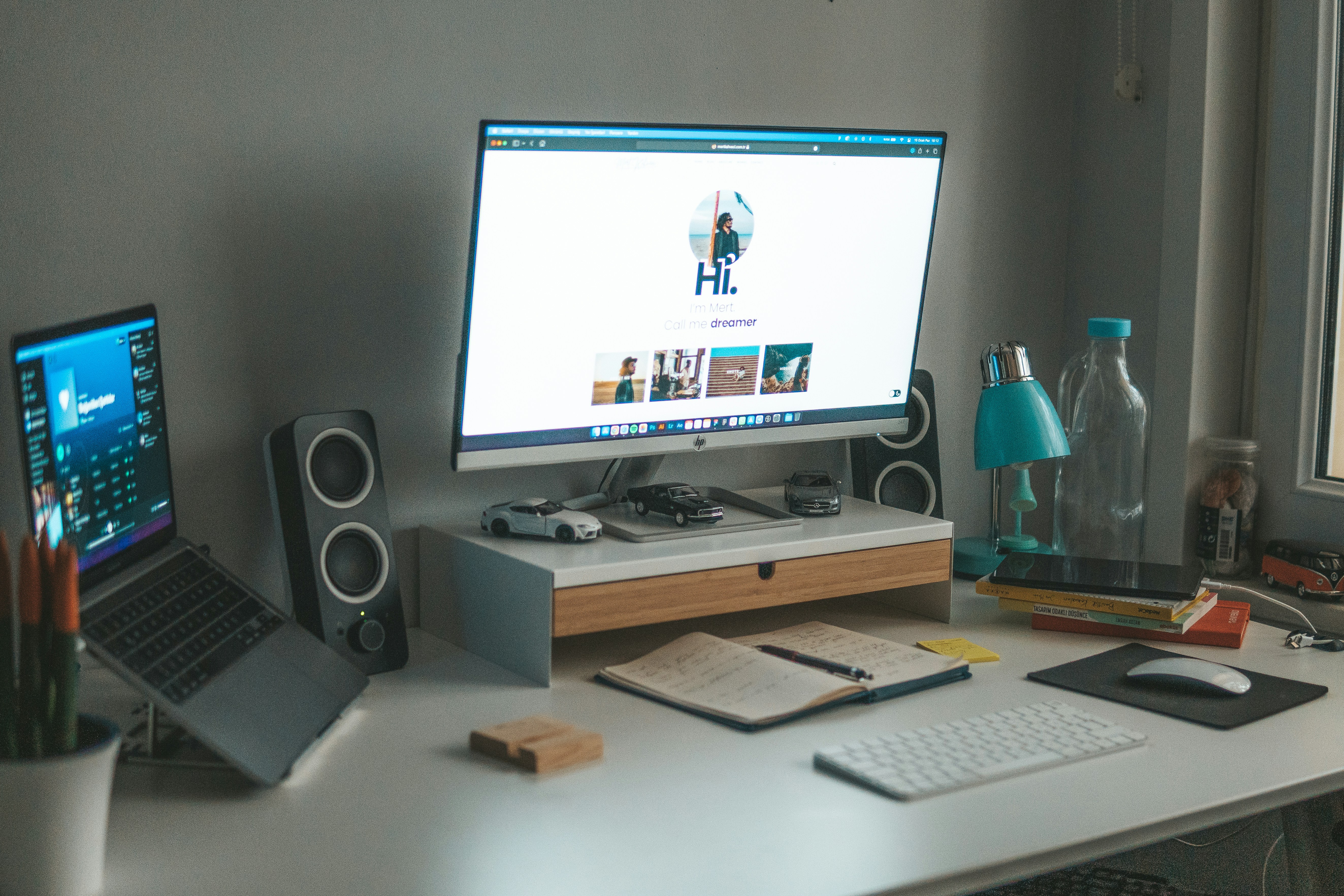 a desk with a computer and a laptop on it