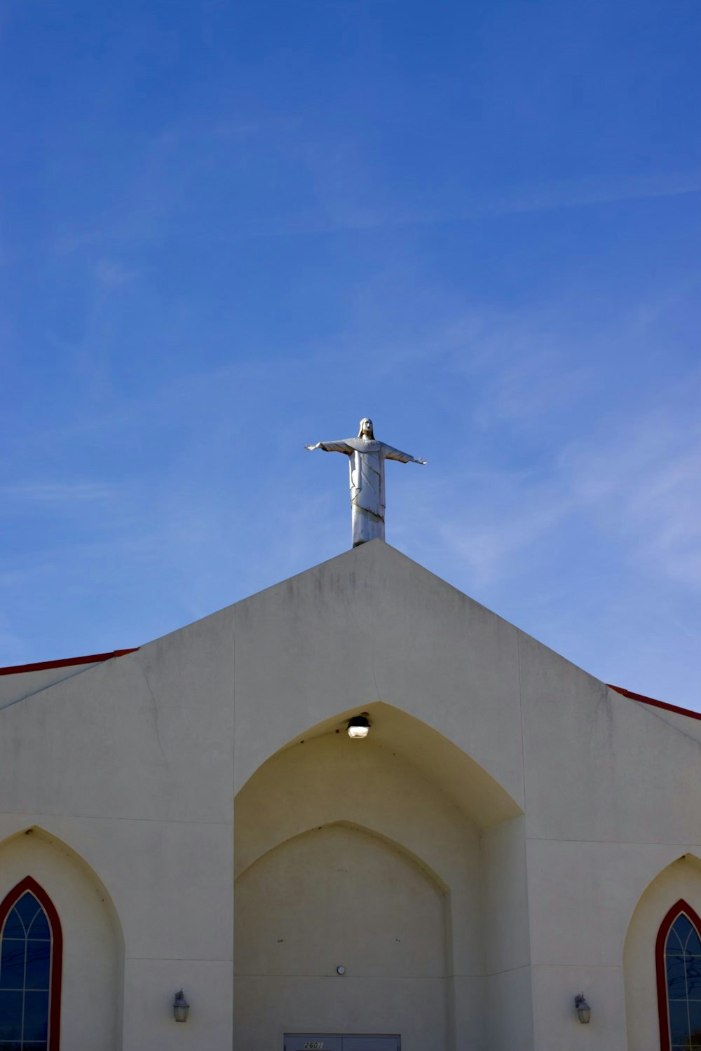 a statue of jesus on top of a church