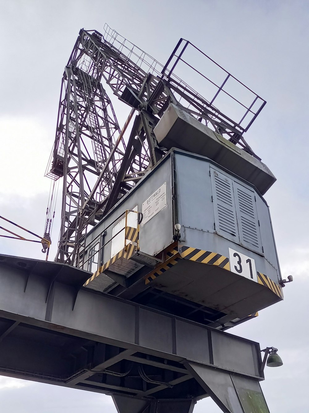 a large crane is on top of a bridge