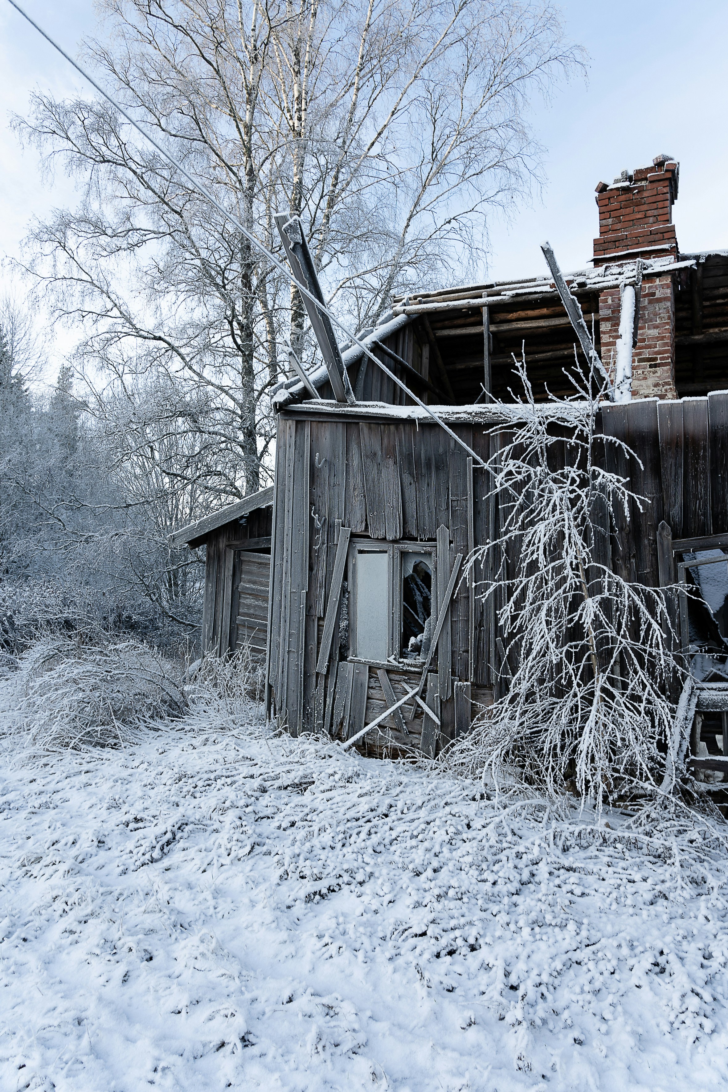 an old run down building in the middle of winter