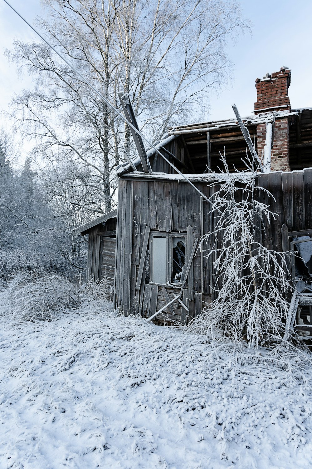 an old run down building in the middle of winter