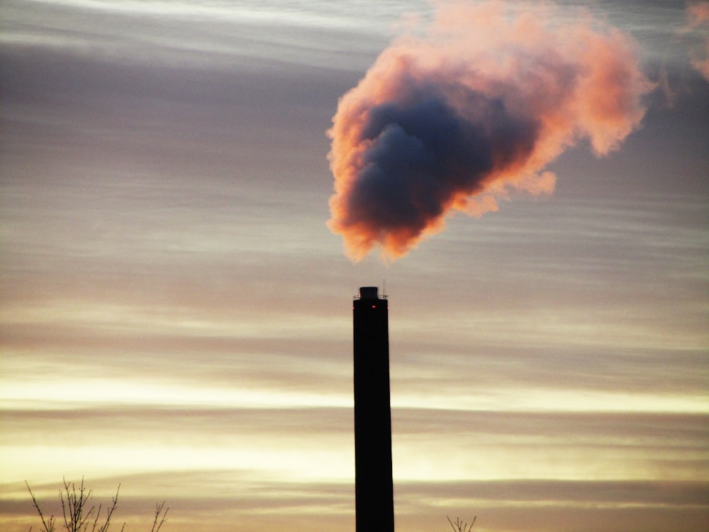 a smokestack emits from a pipe in the sky