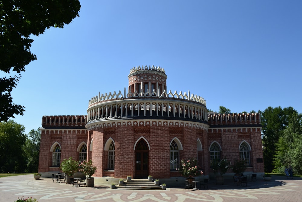 a brick building with a circular roof and many windows