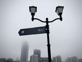 a street light with a street sign attached to it