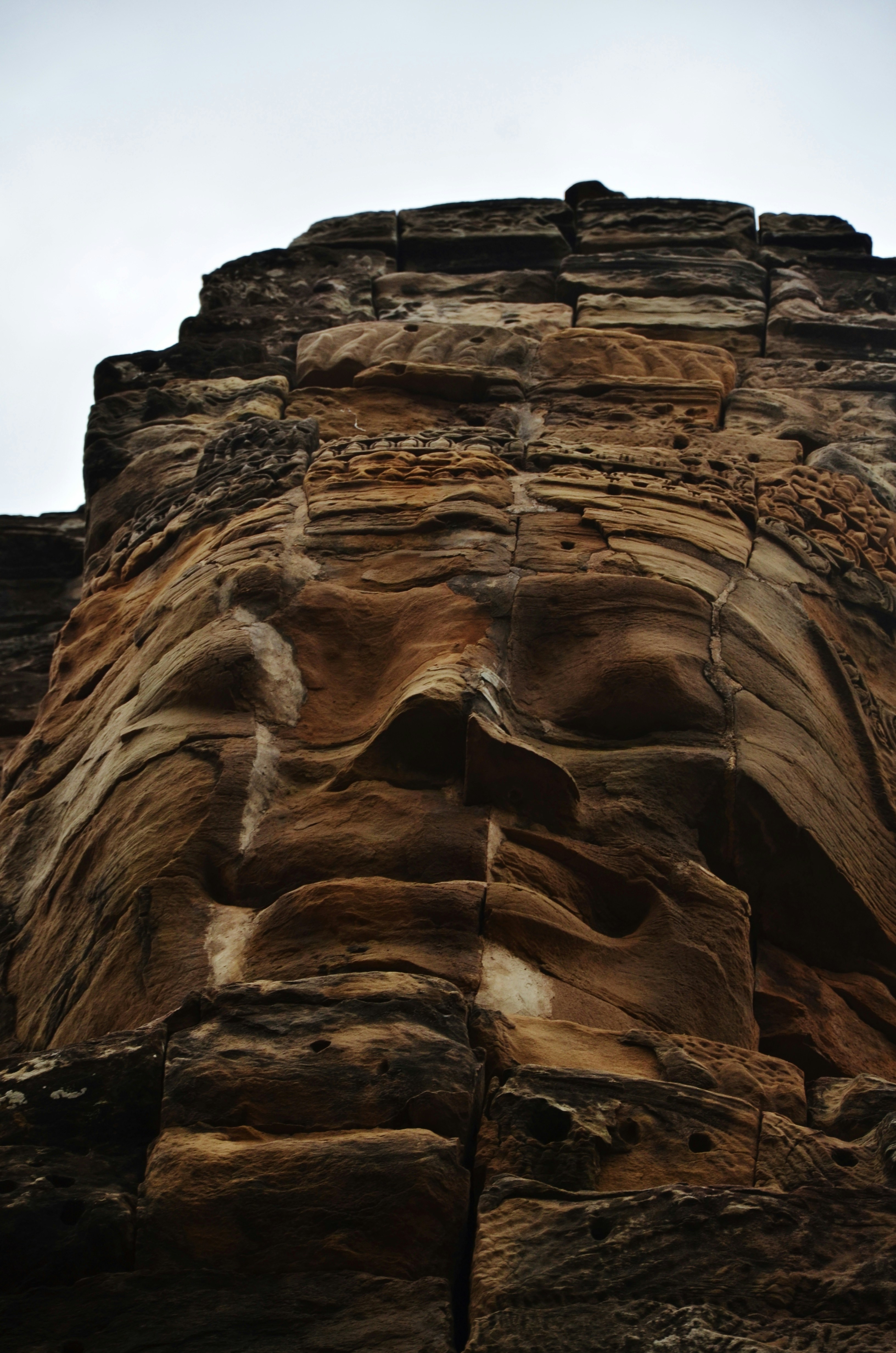 a very tall rock formation with a sky in the background