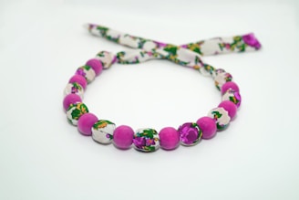 A bright and playful crochet necklace with small flower charms.