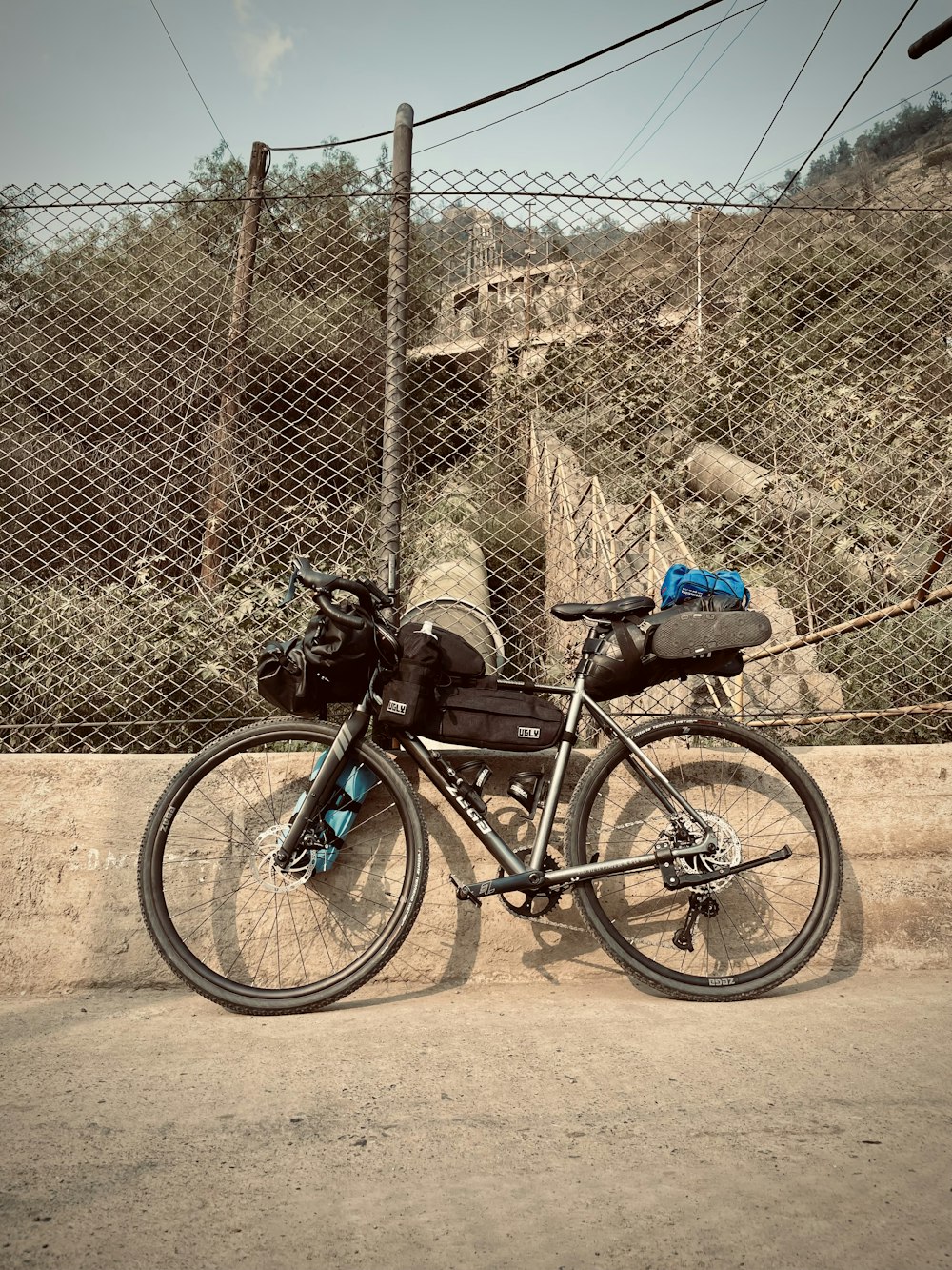 a bicycle is parked next to a fence