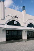 a large white building with a clock on the front of it