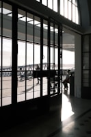 Close-up of a sleek glass door with aluminum framing on a sunny day.
