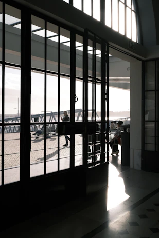 Bright interior showing a 10mm tempered glass folding door partially open, highlighting its smooth folding mechanism.