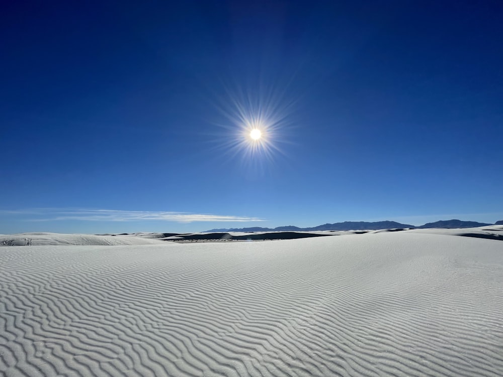 the sun is shining over a vast expanse of snow