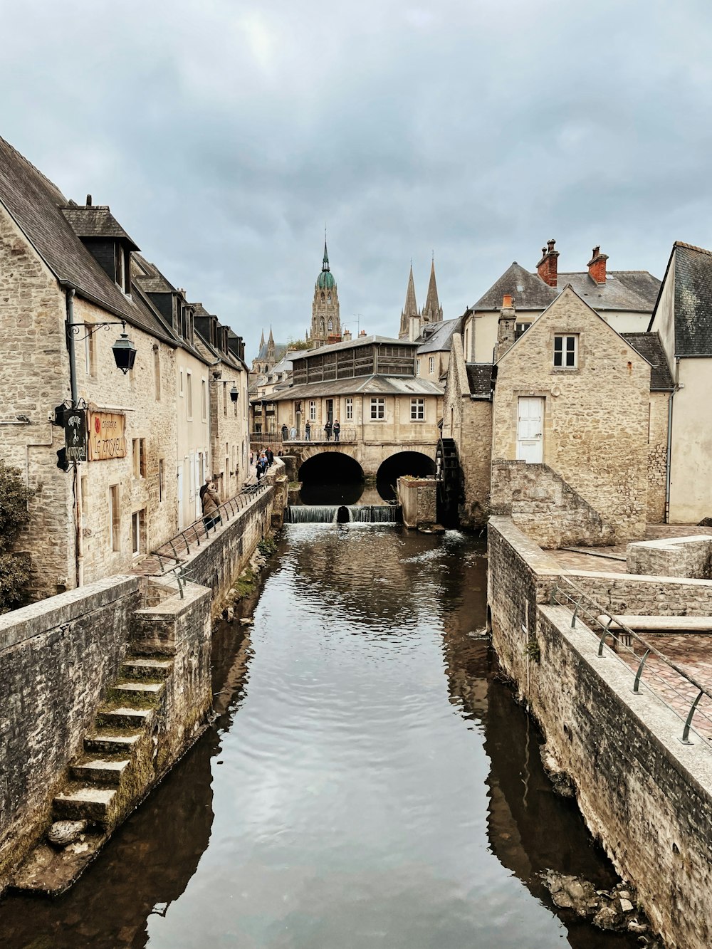 a river running through a city next to tall buildings