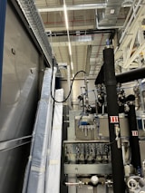 A commercial building with visible heating pipes and systems being serviced by professionals.